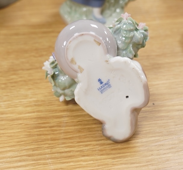 A large Lladro figure group of three ballet dancers by a tall floral column and eight other Lladro figures including a model of a bell. Tallest figure group 45cm high. Condition - golfer group, golf clubs broken.
